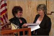 Judy Chicago presenting a Dinner Party book to New Mexico Lt. Governor